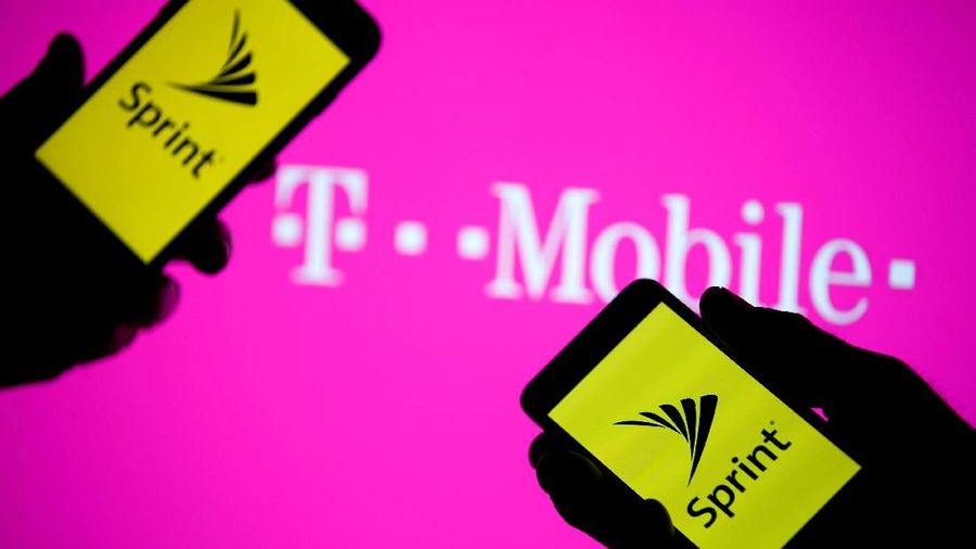 FILE PHOTO: A smartphones with Sprint logo are seen in front of a screen projection of T-mobile logo, in this picture illustration taken April 30, 2018. REUTERS/Dado Ruvic/Illustration/File Photo                   GLOBAL BUSINESS WEEK AHEAD