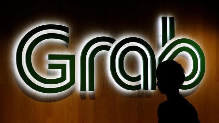 A man passes a Grab signage in their office in Singapore September 23, 2016. REUTERS/Edgar Su