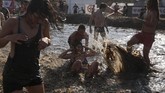 Ini karena di festival tersebut para pengunjung bisa bermain lumpur dan tanah, bahkan ada ajang gulat lumpur di sana. (REUTERS/Kacper Pempel)