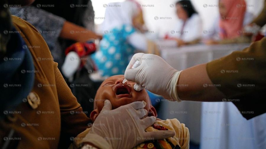 A child who received fake medication from a drug-making ring is revaccinated by government healthcare workers at a clinic in East Jakarta, Indonesia, July 18, 2016. REUTERS/Darren Whiteside