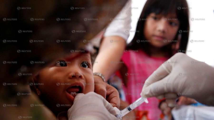 HOLD FOR INDONESIA-HEALTH/A child who received fake medication from a drug-making ring is revaccinated by government health care workers at a clinic in East Jakarta, Indonesia July 18, 2016.REUTERS/Darren Whiteside