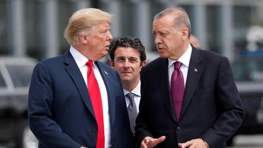 FILE PHOTO: U.S. President Donald Trump and Turkish President Tayyip Erdogan gesture as they talk at the start of the NATO summit in Brussels, Belgium July 11, 2018.  REUTERS/Kevin Lamarque/File Photo