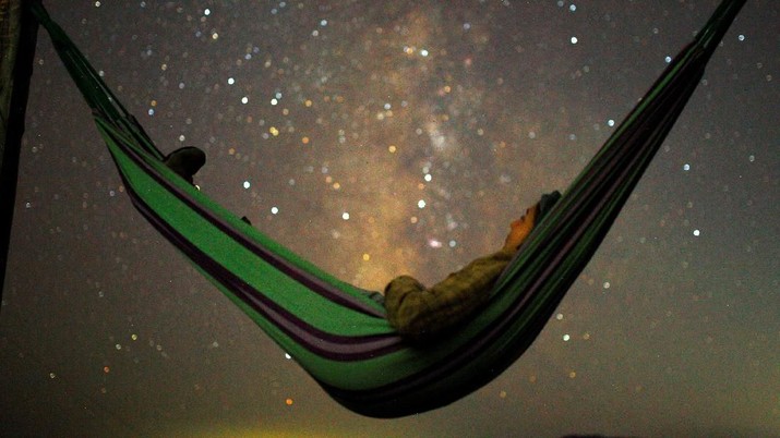 A girl lies in hammock as she looks at the milky way during the peak of Perseid meteor shower in Kozjak, Macedonia August 13, 2018. REUTERS/Ognen Teofilovski