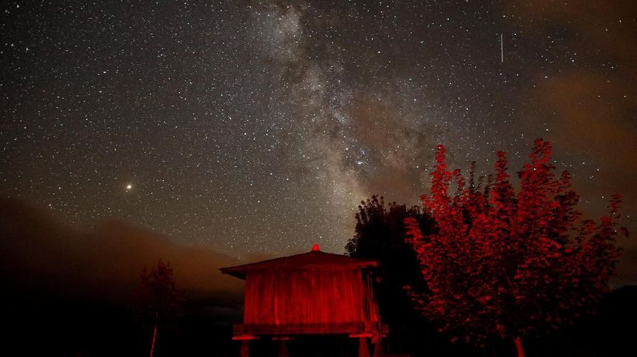 A meteor streaks past stars and the Milky Way in the night sky during the Perseids meteor shower in Berducedo, Spain, August 12, 2018. REUTERS/Paul Hanna