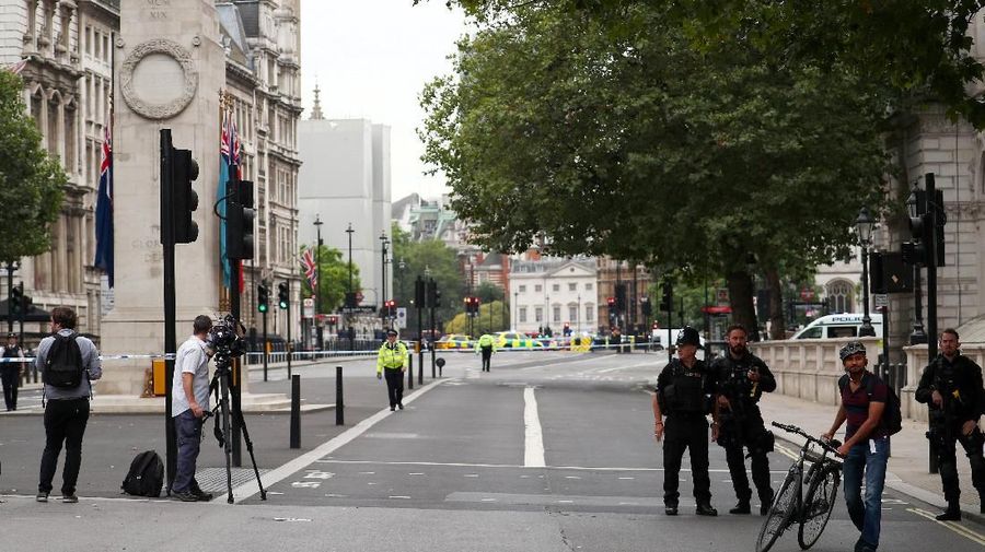 Police stand in the street after a car crashed outside the Houses of Parliament in Westminster, London, Britain, August 14, 2018. REUTERS/Hannah McKay