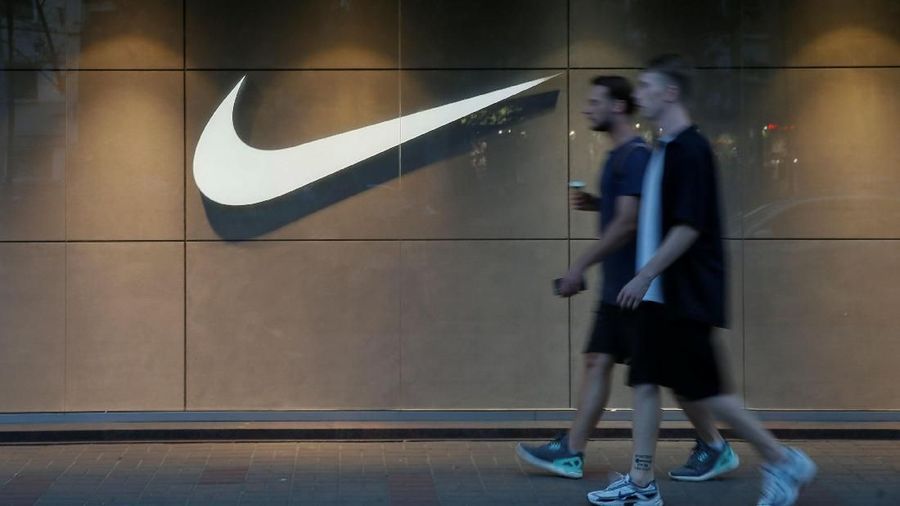 Men walk past a Nike store in central Kiev, Ukraine August 14, 2018. Picture taken August 14, 2018.  REUTERS/Valentyn Ogirenko