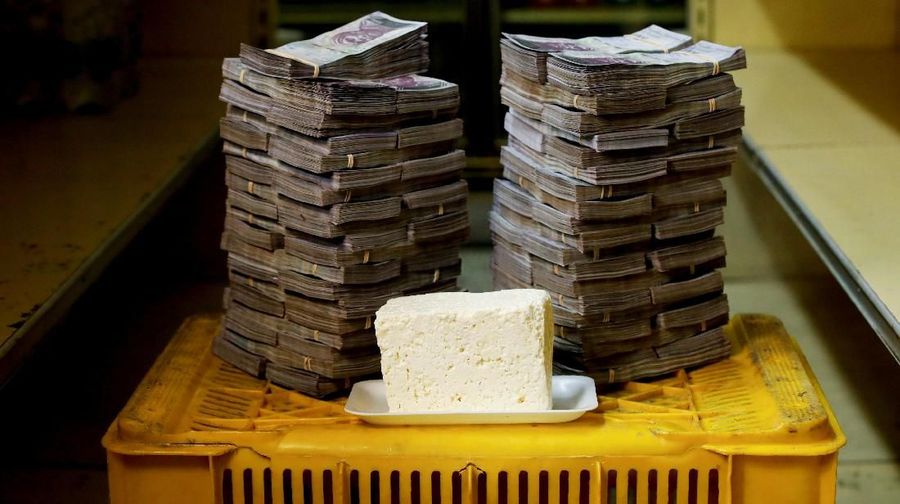 A kilogram of cheese is pictured next to 7,500,000 bolivars, its price and the equivalent of 1.14 USD, at a mini-market in Caracas, Venezuela August 16, 2018. It was the going price at an informal market in the low-income neighborhood of Catia. REUTERS/Carlos Garcia Rawlins SEARCH
