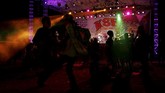 Penggemar Vespa berjoget bersama menikmati riuhnya acara 'Kediri Scooter Festival 2018' di malam hari. (REUTERS/Darren Whiteside)