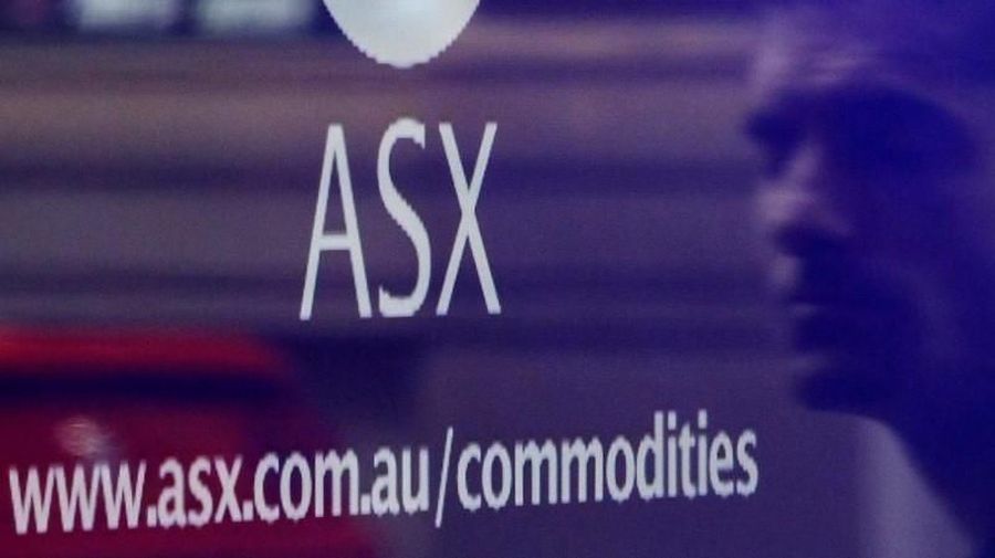 A man is reflected as he walks past the Australian Securities Exchange building in central Sydney April 8, 2011. REUTERS/Daniel Munoz