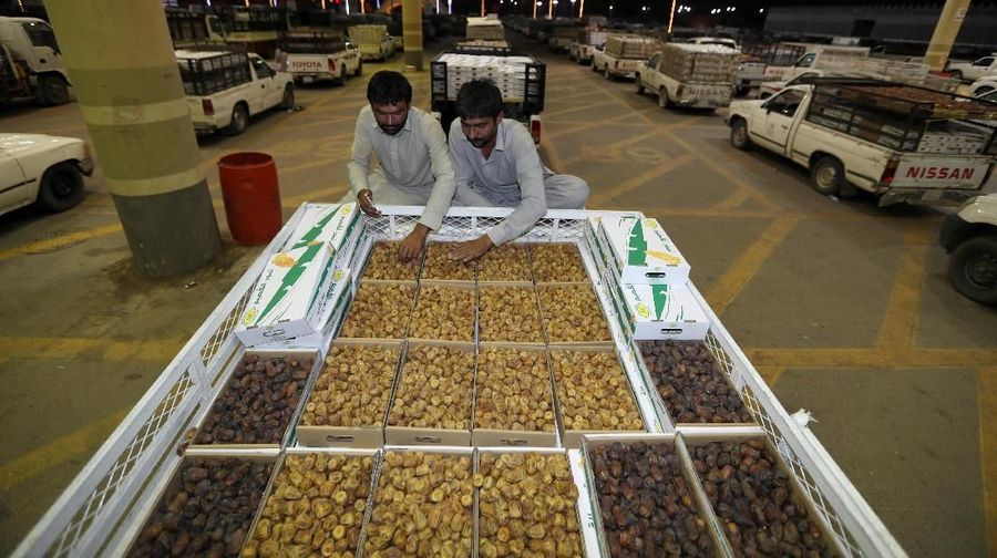 A Saudi man throws dates, as he auctions them during the worldÕs largest dates festival 