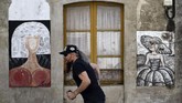 Untuk merapikan karya para seniman yang terus muncul, diadakan sebuah festival menggambar mural di dinding bangunan kawasan tersebut setiap tahunnya dan diberi nama Festival Art Meninas de Canido. (AFP PHOTO / MIGUEL RIOPA)