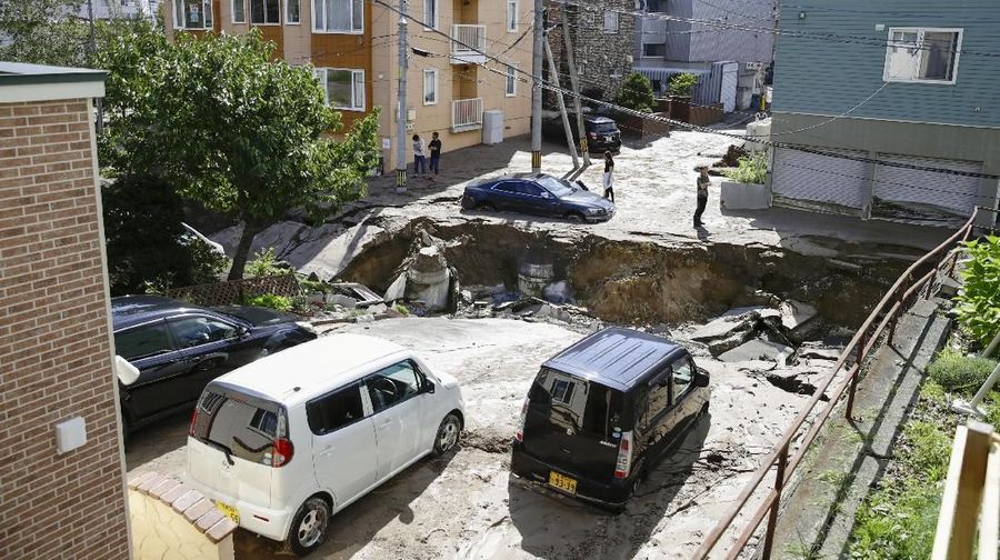 People look at an area damaged by an earthquake in Sapporo in Japan's northern island of Hokkaido, Japan, in this photo taken by Kyodo September 6, 2018. Mandatory credit Kyodo/via REUTERS ATTENTION EDITORS - THIS IMAGE WAS PROVIDED BY A THIRD PARTY. MANDATORY CREDIT. JAPAN OUT. NO COMMERCIAL OR EDITORIAL SALES IN JAPAN.