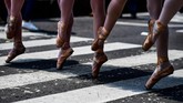 Para murid sekolah balet ini pun mendapatkan tantangan tersendiri kala mesti berjinjit di atas zebra cross yang panas diterpa terik matahari. (AFP PHOTO / RONALDO SCHEMIDT)
