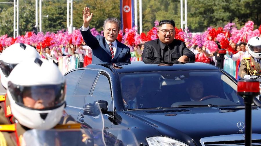 South Korean President Moon Jae-in and North Korean leader Kim Jong Un react during a car parade in Pyongyang, North Korea, September 18, 2018. Pyeongyang Press Corps/Pool via REUTERS