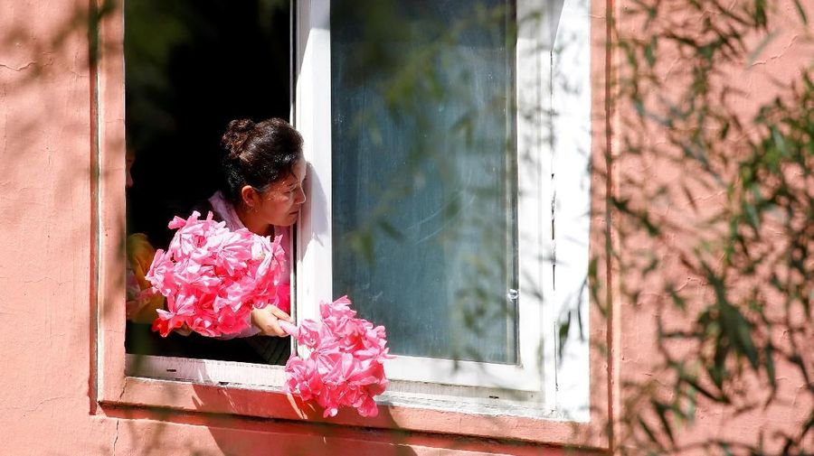 A North Korean woman looks out as South Korean President Moon Jae-in and North Korean leader Kim Jong Un attend a car parade in Pyongyang, North Korea, September 18, 2018. Pyeongyang Press Corps/Pool via REUTERS