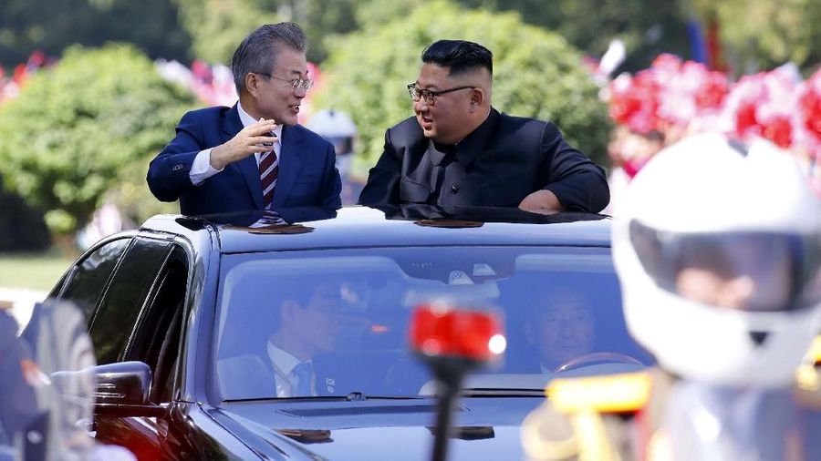 South Korean President Moon Jae-in and North Korean leader Kim Jong Un react during a car parade in Pyongyang, North Korea, September 18, 2018. Pyeongyang Press Corps/Pool via REUTERS