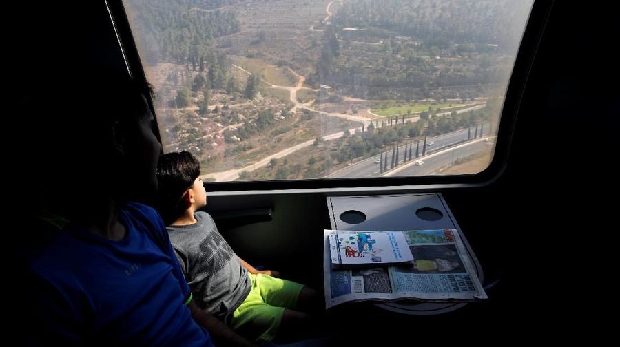 Passengers look out of a window as they travel on Israel's new high-speed rail line from Ben Gurion International Airport to Jerusalem September 25, 2018. REUTERS/Amir Cohen