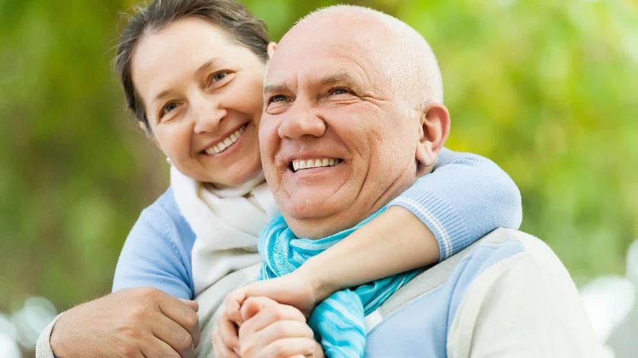 aged couple of pensioners talking with employee at office