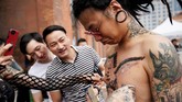 Wei Yilaien menunjukkan hasil karyanya, berupa tindikan di tubuh. Tak hanya tattoo, seni menghias tubuh juga berupa tindikan di anggota tubuh. (REUTERS/Aly Song)