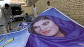 Election posters of parliamentary candidates are installed on a street while a boy walks past in Jalalabad, Afghanistan October 6, 2018. Picture taken October 6, 2018. REUTERS/Parwiz