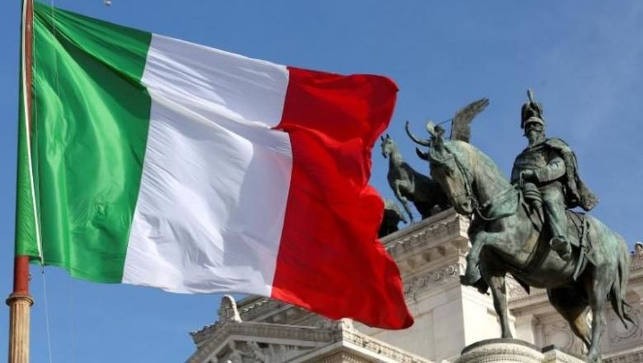The Italian flag waves in front of The 