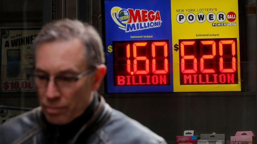 Signs display the jackpots for Tuesday's Mega Millions and Wednesday's Powerball lottery drawings in New York City, U.S., October 22, 2018. REUTERS/Brendan McDermid