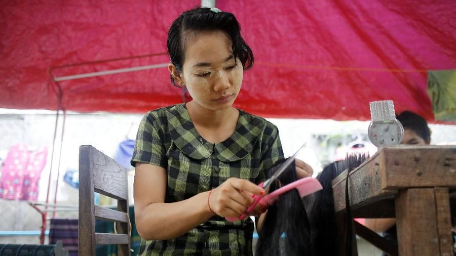 Workers clean the hair for export at Tet Nay Lin Trading Co. in Yangon, Myanmar, June 19, 2018. Picture taken June 19, 2018. REUTERS/Ann Wang