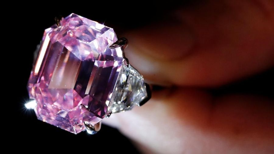 A Christie's staff holds a 18.96 carat Fancy Vivid Pink Diamond during a preview in Geneva, November 8, 2018. REUTERS/Denis Balibouse  TPX IMAGES OF THE DAY