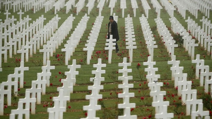 A man walks among the tombstones at the cemetery outside the WWI Douaumont Ossuary, as France prepares to mark the centenial commemoration of the First World War Armistice Day, near Verdun, France,  November 5, 2018. Picture taken November 5, 2018. REUTERS/Christian Hartmann