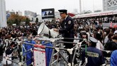 Petugas keamanan dikerahkan untuk menjaga penonton sekaligus mengamankan kondisi di bagian luar lokasi konser BTS di Tokyo, Jepang. (REUTERS/Kim Kyung-Hoon)