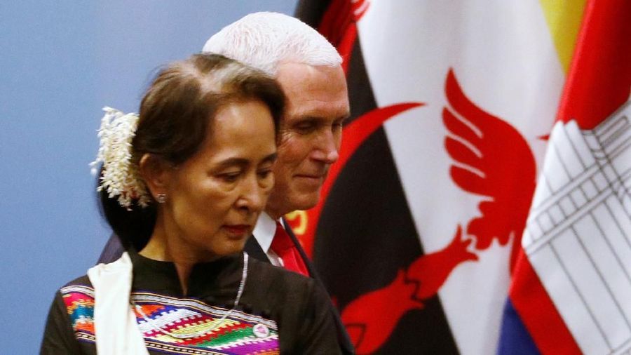 U.S. Vice President Mike Pence passes by Myanmar’s leader Aung San Suu Kyi as he arrives for a group photo with ASEAN leaders at the ASEAN-U.S. Summit in Singapore November 15, 2018. REUTERS/Edgar Su