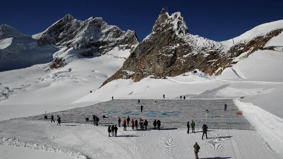 A general view shows 100,000 postcards with messages against climate change, sent by young people from all over the world and stuck together to break the Guinness World Record of the biggest postcard on the Jungfraufirn, the upper part of Europe's longest glacier, the Aletschgletscher, near Jungfraujoch, Switzerland November 16, 2018. REUTERS/Arnd Wiegmann