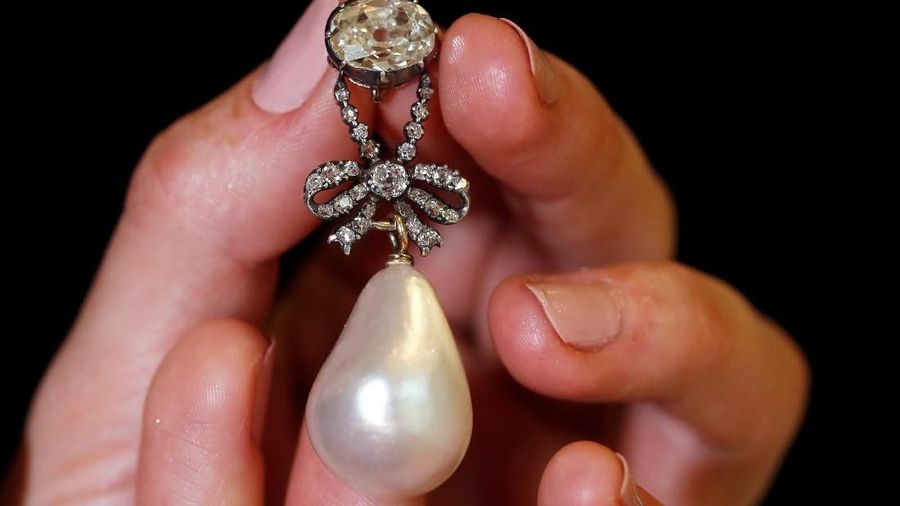 Liontion Mutiara Termahal Dunia perhiasan milik mantan Ratu Prancis Marie Antoinette. (REUTERS/Denis Balibouse) A natural pearl and diamond pendant once owned by Marie Antoinette is held by a model during a press preview ahead of the upcoming auction