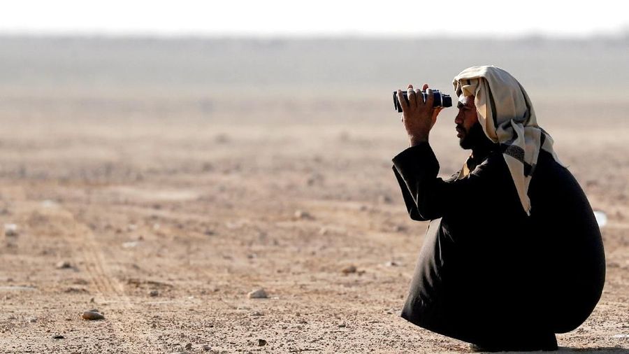 Members of Egy Falconer Club and austringers look at sunrise during a celebration on World Falconry Day at Borg al-Arab desert in Alexandria, Egypt, November 17, 2018. Picture taken November 17, 2018. REUTERS/Amr Abdallah Dalsh