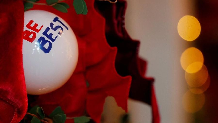 A Christmas ornament with first lady Melania Trump's slogan is seen nestled in garland lining a fireplace during the 2018 Christmas Press Preview at the White House in Washington, U.S., November 26, 2018. REUTERS/Leah Millis
