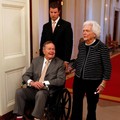 FILE PHOTO: Former U.S. President George H. W. Bush (L) and former first lady Barbara Bush enter the East Room of the White House before the ceremony unveiling the official White House portraits of former President George W. Bush and former first lad