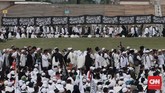 Bendera bertuliskan kalimat tauhid juga dipajang di sekitar lokasi Reuni Aksi 212, Monas, Jakarta Pusat. Beberapa peserta juga berfoto di depan spanduk bertuliskan 'Dengan Tauhid Kita Menuju Kejayaan NKRI, Bela Tauhid Bela NKRI'. (CNN Indonesia/Andry Novelino)