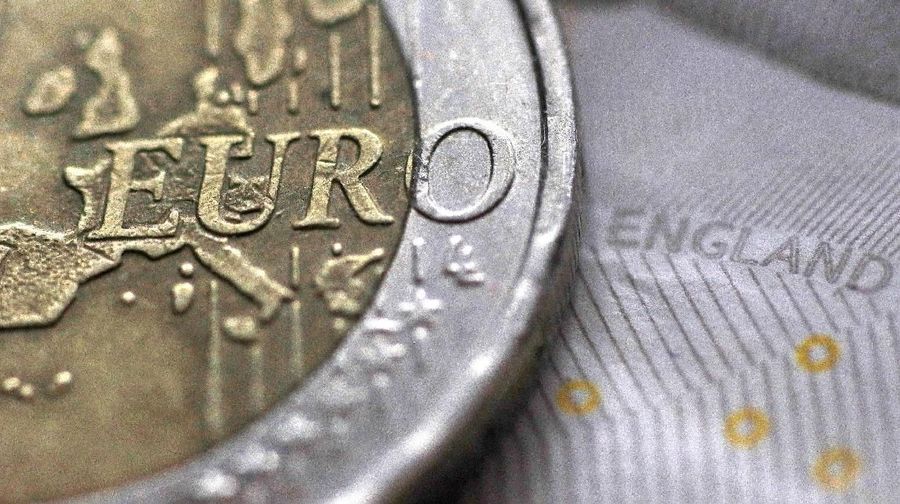 FILE PHOTO: A two Euro coin is pictured next to an English ten Pound note in an illustration taken March 16, 2016.  REUTERS/Phil Noble/Illustration/File Photo/File Photo