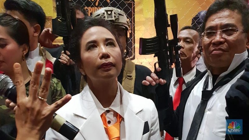 Gaya Menteri Rini datang dengan Jas Putih dasi oren dan membawa peralatan masakan.
