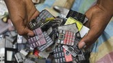 Di rumahnya, Koffi menghancurkan ponsel-ponsel itu untuk memisahkan layar dan keyboards. Keduanya adalah elemen penting untuk proyek seni ini. (REUTERS/Luc Gnago)