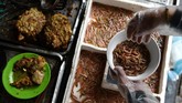 Cha ruoi berupa segepok kue atau roti berisi daging babi, telur, kulit jeruk, dan segenggam cacing goreng. Makanan favorit ini dijajakan di sederet warung di jalanan Kota Hanoi. (Photo by Manan VATSYAYANA/AFP)