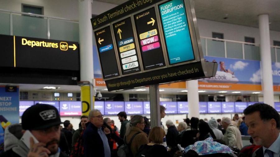 Passengers walk with suitcases in Gatwick Airport, in Crawley, Britain, December 22, 2018. REUTERS/Peter Nicholls