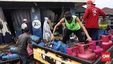 Warga merapikan tabung-tabung gas di antara reruntuhan sisa tsunami di Desa Sumberjaya, Kecamatan Sumur, Pandeglang, Banten, Senin (24/12). CNN Indonesia/Hesti Rika