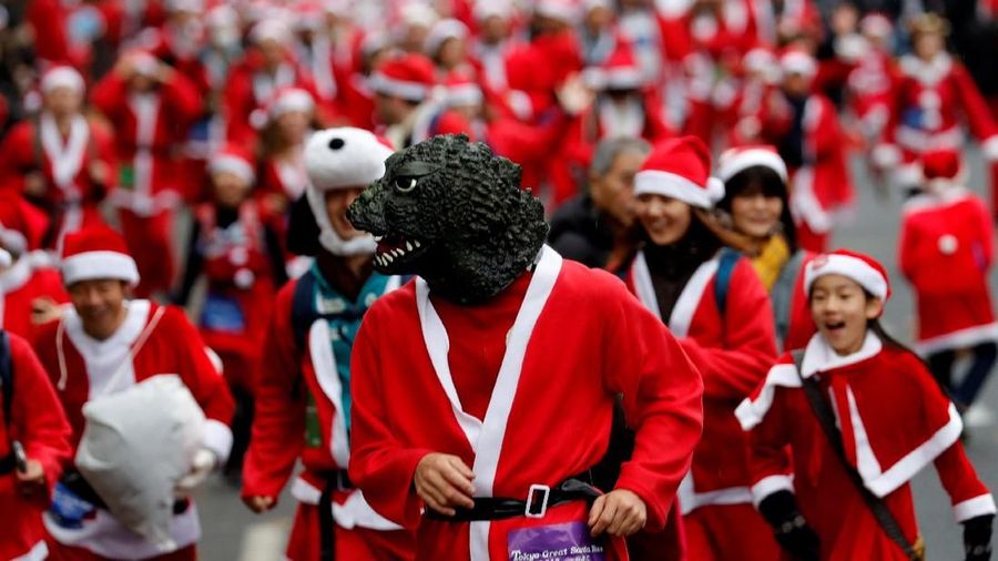 Participants dressed as Santa Claus take part in a charity event 
