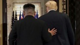 Pemimpin tertinggi Korea Utara, Kim Jong-un, berjalan bersama Presiden Amerika Serikat, Donald Trump, setelah mengumumkan hasil pertemuan kedua kepala negara di Singapura, momen yang disebut-sebut sebagai momentum awal mula upaya denuklirisasi. (REUTERS/Jonathan Ernst)