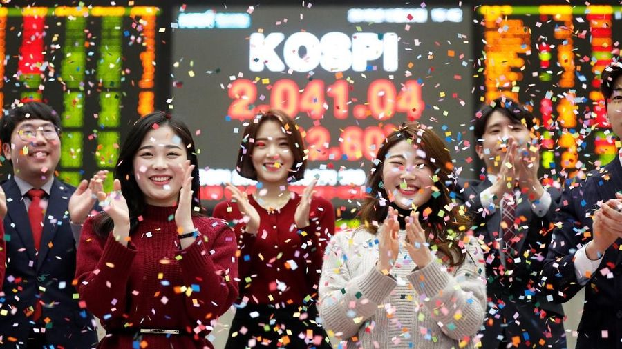 Employees of the Korea Exchange (KRX) pose in front of the final stock price index during a photo opportunity for the media at the ceremonial closing event of the 2018 stock market in Seoul, South Korea, December 28, 2018.    REUTERS/Kim Hong-Ji