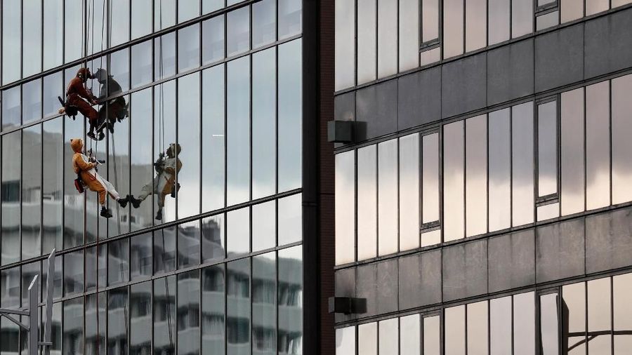 Window cleaners, dressed as a dog (R) and wild boar, this year's and next year's Chinese zodiac animals, pose while cleaning the windows of Ryumeikan hotel during a promotional event to celebrate the upcoming new year in Tokyo, Japan, December 13, 2018. REUTERS/Kim Kyung-Hoon TPX IMAGES OF THE DAY