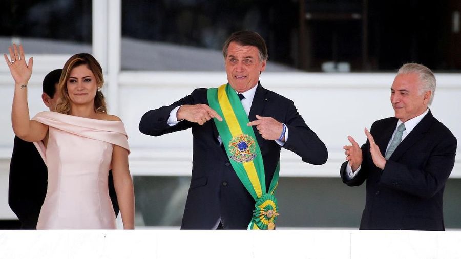 Brazil's new President Jair Bolsonaro gestures after receiving the presidential sash from outgoing President Michel Temer at the Planalto Palace, in Brasilia, Brazil January 1, 2019. REUTERS/Sergio Moraes TPX IMAGES OF THE DAY