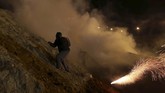 Ratusan imigran melawan lontaran gas air mata dengan melempar batu ke arah petugas Penjaga Perbatasan dan Bea Cukai (CBP) AS. (REUTERS/Mohammed Salem)