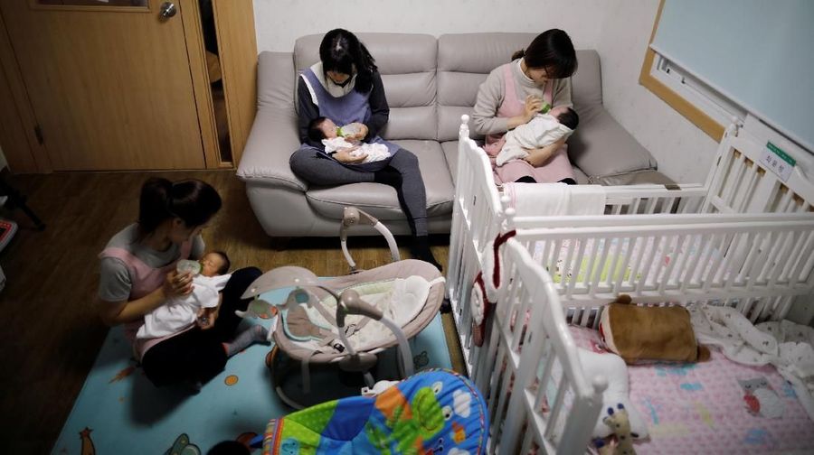 Kim Mi-sung checks her daughter's homework before leaving for school, at their home in Seoul, South Korea, December 19, 2018. Picture taken December 19, 2018.   REUTERS/Kim Hong-Ji